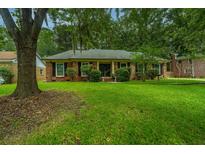 Brick ranch house with a well-manicured lawn and mature trees at 109 Old Tavern Ln, Summerville, SC 29485