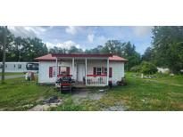 Small cottage with red roof, porch and simple landscaping at 189 Joe Felder Rd, Ridgeville, SC 29472