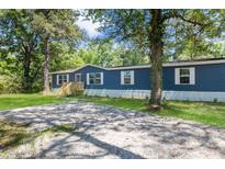 Blue mobile home with white trim, wooden deck and spacious yard at 227 Koger Dr, Summerville, SC 29483