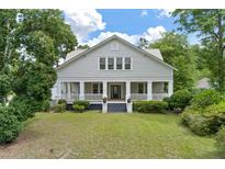 Charming two-story house with a wrap-around porch and mature landscaping at 205 Valley St, Walterboro, SC 29488