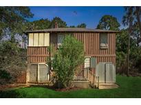Rustic two-story home with wood siding and small deck at 712 W Ashley Ave, Folly Beach, SC 29439