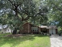 Brick house with large tree and driveway at 1056 Yorktown Dr, Charleston, SC 29412
