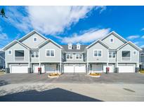 Gray siding townhomes with attached garages and landscaping at 420 Carolina Cherry Ct # 201, Charleston, SC 29414