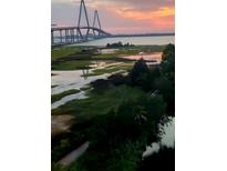 Scenic view of the Arthur Ravenel Jr. Bridge at sunset over marshland at 252 Cooper River Dr, Mount Pleasant, SC 29464