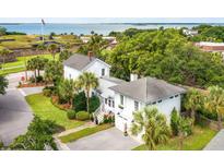 Aerial view of charming two-story home with a detached garage, situated near historic landmarks at 1220 Middle St, Sullivans Island, SC 29482