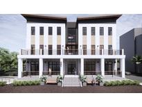 Modern two-story building with a covered porch, balconies, and stylish architectural features at 211 Seven Farms Dr # 202, Charleston, SC 29492