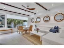Bright living room with white sectional sofa and dining area at 40 Morris St, Charleston, SC 29403