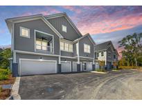 Gray townhouses with attached garages, and a shared driveway at 420 Carolina Cherry Ct # 203, Charleston, SC 29414