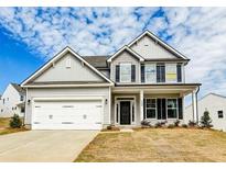 Two-story house with gray siding, white garage doors, and landscaping at 111 Ashley Cove Way, Summerville, SC 29483