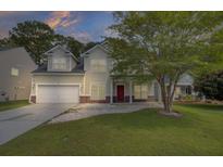 Two story house with front porch and attached garage at 124 Sweet Alyssum Dr, Ladson, SC 29456