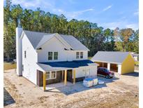 New house and detached garage under construction, viewed from above at 517 Rendezvous Way, Huger, SC 29450