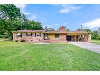 Brick ranch house with carport, situated on a spacious lot at 1144 Old Mill Rd, Saint Stephen, SC 29479