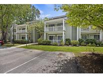 Green exterior of building with white trim, balconies, and parking at 2317 Tall Sail Dr # 1007 G, Charleston, SC 29414