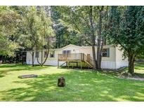 Single-wide mobile home with a deck and a large yard at 121 Paisan Rd, Summerville, SC 29483