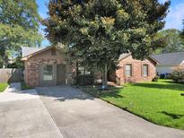 Brick house with a large tree and grassy yard at 3264 Heaton Dr, Ladson, SC 29456