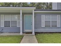 Gray house exterior with a light blue front door and white shutters at 9510 Raven Dr, Ladson, SC 29456