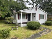 Charming one-story home with white siding and maroon shutters at 1032 Greenhill Rd, Charleston, SC 29412