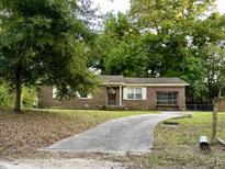 Brick ranch house with a driveway and mature trees at 1141 Bonnie Ln, Mount Pleasant, SC 29464