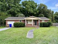 Brick ranch home with a landscaped lawn and walkway at 1149 Quail Dr, Charleston, SC 29412