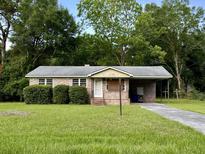 Brick ranch home with carport and mature landscaping at 1344 Teal Ave, Charleston, SC 29412
