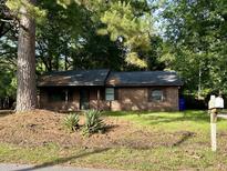 Charming brick ranch home nestled amongst lush greenery at 1867 Grover Rd, Johns Island, SC 29455