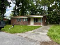 Brick ranch house with a driveway and front yard at 2628 Clara Ln, North Charleston, SC 29406