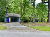 Ranch style home with a carport and mature trees at 2651 Leeds Ave, North Charleston, SC 29405