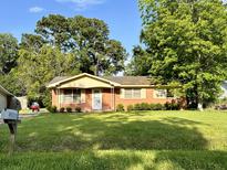 Brick ranch house with a well-maintained lawn at 586 Kell Pl, Charleston, SC 29412