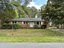 Brick ranch home with a large yard and mature trees at 7042 Midland Dr, North Charleston, SC 29406