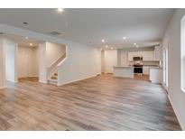 Open concept living room and kitchen with hardwood floors at 293 Shadybrook Dr, Summerville, SC 29486