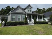 Charming two-story house with gray siding and a white porch at 86 Watershed Ct, Walterboro, SC 29488