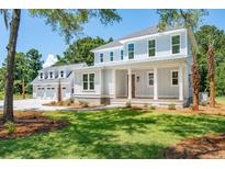 Two-story home with gray siding, a front porch, and a three-car garage at 3351 Westphal Dr, Johns Island, SC 29455