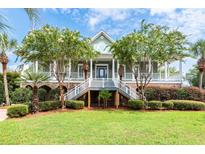 Two-story home with front porch and lush landscaping at 687 Oak Marsh Dr, Mount Pleasant, SC 29464