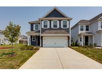 Two-story home with a gray exterior, white trim, and a two-car garage at 8800 Credence Dr, North Charleston, SC 29420