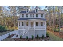 Two story house with front porch and attached garage at 509 Twin Lakes Dr, Summerville, SC 29483