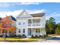 Two-story home with gray siding, white trim, and a front porch at 2261 Blue Bayou Blvd, Johns Island, SC 29455
