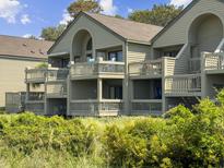 Two-story building with multiple balconies and lush landscaping at 1309 Pelican Watch Villas, Seabrook Island, SC 29455