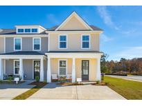 Two-story tan and gray townhome with a front porch and two-car driveway at 229 Abercom Place Dr, Moncks Corner, SC 29461