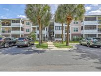 Apartment building exterior with parking and palm trees at 1025 Riverland Woods Pl # 610, Charleston, SC 29412