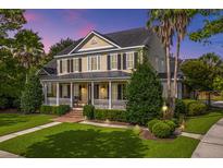 Two-story home with wrap-around porch, mature landscaping, and sunset view at 775 Navigators Run, Mount Pleasant, SC 29464