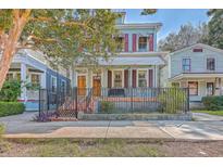 Charming two-story home with light blue siding, red shutters, and a brick walkway at 380 Ashley Ave, Charleston, SC 29403