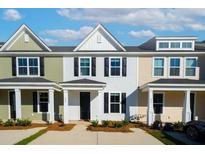 Three-unit townhouse building with front porches and attached garages at 223 Abercom Place Dr, Moncks Corner, SC 29461