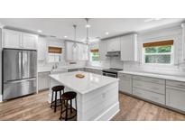 Modern kitchen with white cabinets, stainless steel appliances, and a large island at 970 Key Colony Ct, Mount Pleasant, SC 29464
