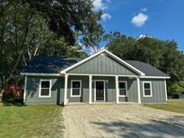 Newly built gray house with a sandy driveway at 102 Whitesville Rd, Moncks Corner, SC 29461