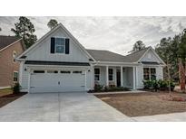 Charming farmhouse exterior with white siding, black shutters, and a two-car garage at 366 Wappoo Trace Ln, Summerville, SC 29486