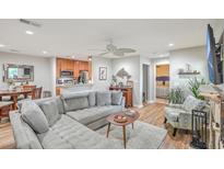 Open living room with gray sectional sofa, wood floors, and a fireplace at 266 Alexandra Dr # 15, Mount Pleasant, SC 29464