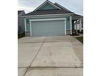 Two-car garage and light gray exterior with stone accents at 741 Blue Iris Way, Summerville, SC 29486