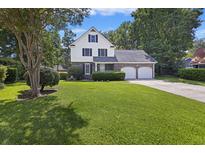 Two-story home with double garage and manicured lawn at 5 Avon Ct, Charleston, SC 29407