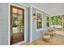 Inviting front porch with wooden chairs and a blue exterior at 361 Wappoo Trace Ln, Summerville, SC 29486