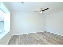 Bright bedroom with neutral walls, wood-look flooring, and ceiling fan at 1910 Tropicana Rd # 9-B, North Charleston, SC 29406